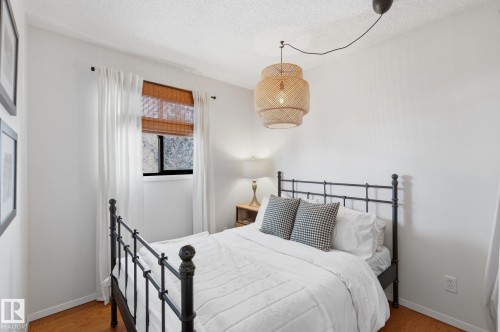 Bedroom with wood finished floors and a textured ceiling - 18717 57 Avenue, Edmonton, AB - Indoor Photo Showing Bedroom