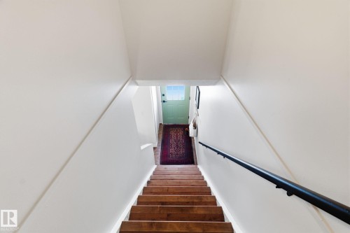 Stairway with wood finished floors - 18717 57 Avenue, Edmonton, AB - Indoor Photo Showing Other Room