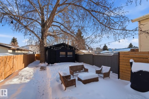 Yard covered in snow featuring a fenced backyard and an outdoor structure - 18717 57 Avenue, Edmonton, AB - Outdoor