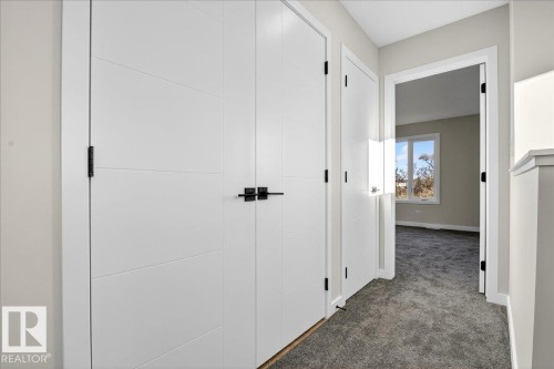 Hallway with dark carpet and baseboards - 10506 162 Street, Edmonton, AB - Indoor Photo Showing Other Room