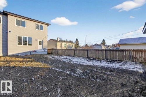 Snow covered property featuring a fenced backyard and a residential view - 10506 162 Street, Edmonton, AB - Outdoor