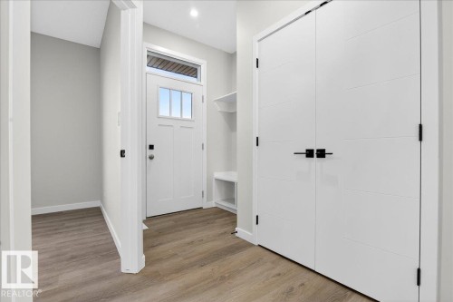 Mudroom featuring light wood-style flooring and baseboards - 10506 162 Street, Edmonton, AB - Indoor Photo Showing Other Room