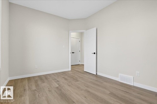 Empty room with baseboards and light wood finished floors - 10506 162 Street, Edmonton, AB - Indoor Photo Showing Other Room