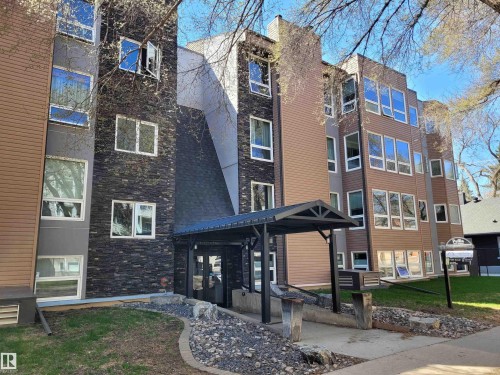 Multi-story building featuring textured dark stone paneling and horizontal brown siding - 44 10172 118 Street, Edmonton, AB - Outdoor