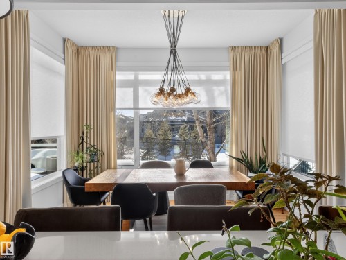 Dining area featuring plenty of natural light, wood finished floors, and suspended lighting - 5507 Chegwin Point(E), Edmonton, AB - Indoor Photo Showing Dining Room