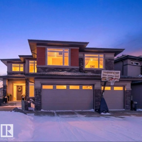 Prairie-style house featuring stone siding and a garage - 5507 Chegwin Point(E), Edmonton, AB - Outdoor