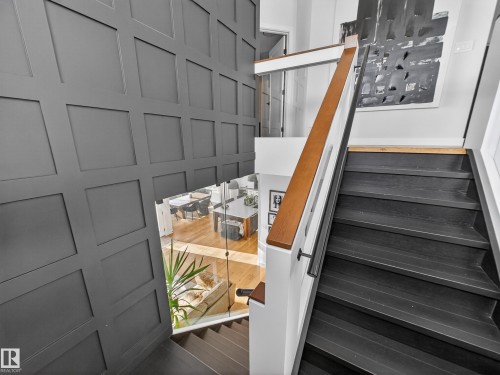Staircase featuring wood finished floors and a decorative wall - 5507 Chegwin Point(E), Edmonton, AB - Indoor Photo Showing Other Room