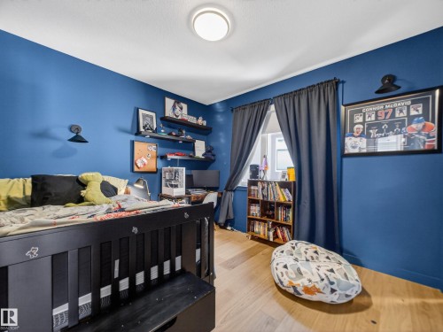 Bedroom featuring wood finished floors - 5507 Chegwin Point(E), Edmonton, AB - Indoor Photo Showing Other Room