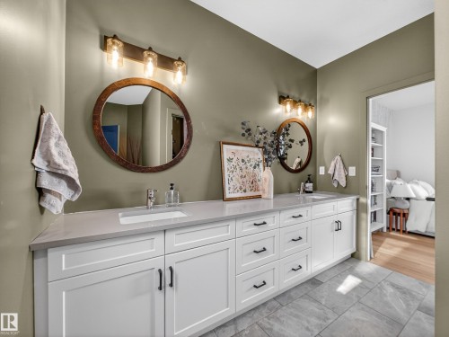Bathroom featuring double vanity, light marble finish flooring, and ensuite bath - 5507 Chegwin Point(E), Edmonton, AB - Indoor Photo Showing Bathroom