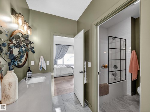 Full bath featuring vanity, shower / bath combination with glass door, and ensuite bath - 5507 Chegwin Point(E), Edmonton, AB - Indoor Photo Showing Other Room