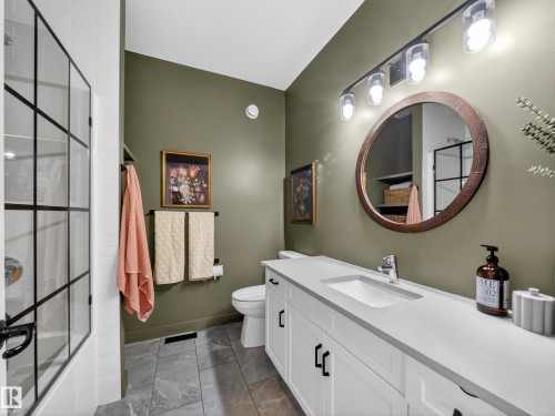 Bathroom with vanity and bath / shower combo with glass door - 5507 Chegwin Point(E), Edmonton, AB - Indoor Photo Showing Bathroom