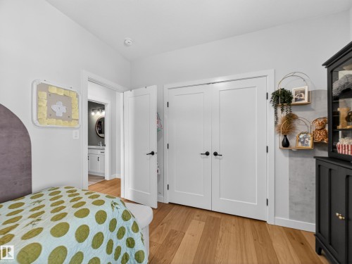 Bedroom with light wood finished floors and a closet - 5507 Chegwin Point(E), Edmonton, AB - Indoor Photo Showing Bedroom