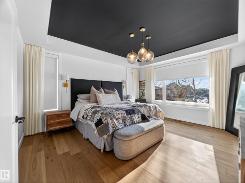Bedroom with a tray ceiling and wood-type flooring - 5507 Chegwin Point(E), Edmonton, AB - Indoor Photo Showing Bedroom