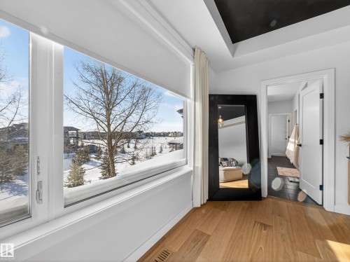 Hall with light wood finished floors and baseboards - 5507 Chegwin Point(E), Edmonton, AB - Indoor Photo Showing Other Room