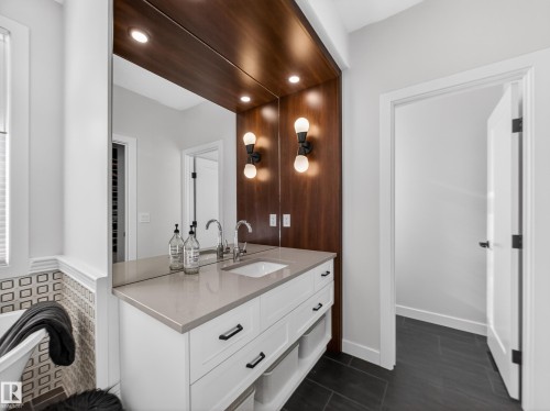 Bathroom featuring vanity, a freestanding bath, recessed lighting, and dark tile patterned floors - 5507 Chegwin Point(E), Edmonton, AB - Indoor Photo Showing Bathroom