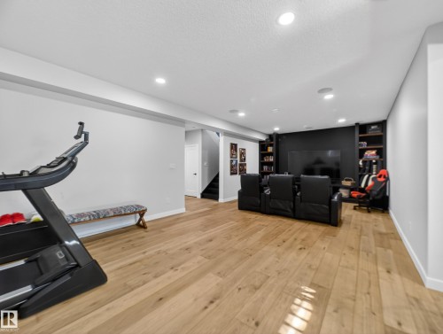 Workout area with light wood-style floors, a textured ceiling, and recessed lighting - 5507 Chegwin Point(E), Edmonton, AB - Indoor Photo Showing Gym Room