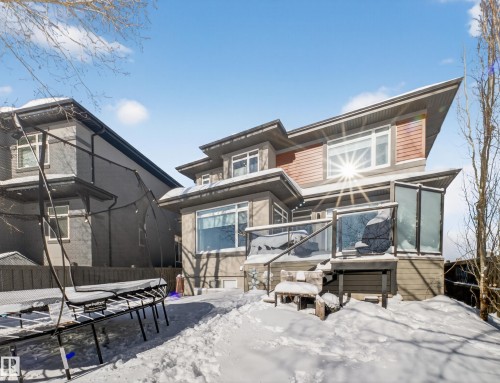 Snow covered back of property with a sunroom and a trampoline - 5507 Chegwin Point(E), Edmonton, AB - Outdoor