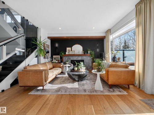 Living room with a fireplace, light wood-style floors, and recessed lighting - 5507 Chegwin Point(E), Edmonton, AB - Indoor Photo Showing Living Room With Fireplace