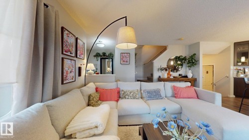 Living area with wood finished floors and a textured ceiling - 1275 Chappelle Boulevard Sw, Edmonton, AB - Indoor Photo Showing Living Room