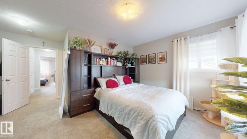 Bedroom with light colored carpet and a textured ceiling - 1275 Chappelle Boulevard Sw, Edmonton, AB - Indoor Photo Showing Bedroom
