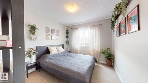 Bedroom featuring a textured ceiling and carpet flooring - 1275 Chappelle Boulevard Sw, Edmonton, AB - Indoor Photo Showing Bedroom