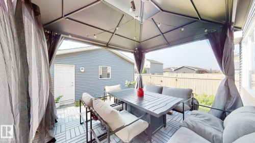 Wooden deck with outdoor dining area and a gazebo - 1275 Chappelle Boulevard Sw, Edmonton, AB - Outdoor With Deck Patio Veranda With Exterior