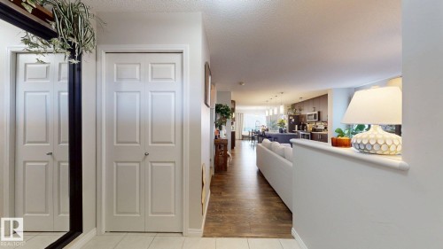 Hall featuring a textured ceiling and light tile patterned floors - 1275 Chappelle Boulevard Sw, Edmonton, AB - Indoor Photo Showing Other Room
