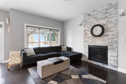 Living area with hardwood / wood-style floors and a fireplace - 56 Durrand Bend, Fort Saskatchewan, AB - Indoor Photo Showing Living Room With Fireplace