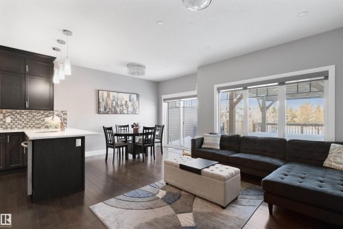 Living area featuring dark wood-type flooring - 56 Durrand Bend, Fort Saskatchewan, AB - Indoor Photo Showing Living Room