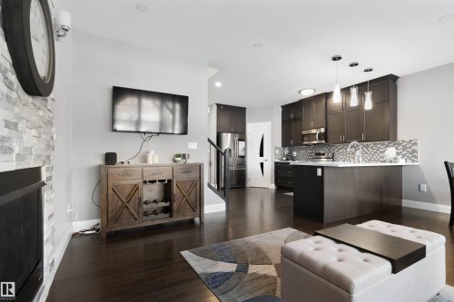 Living room with dark wood-type flooring and a fireplace - 56 Durrand Bend, Fort Saskatchewan, AB - Indoor