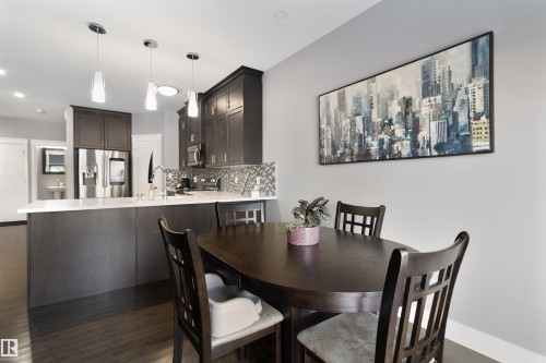 Dining area featuring dark wood-type flooring and baseboards - 56 Durrand Bend, Fort Saskatchewan, AB - Indoor Photo Showing Dining Room