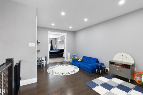 Recreation room featuring dark wood finished floors and recessed lighting - 56 Durrand Bend, Fort Saskatchewan, AB - Indoor