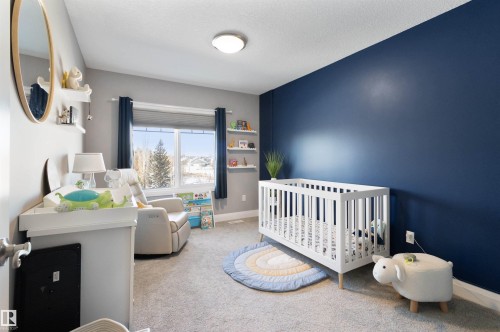 Bedroom featuring a nursery area and light carpet - 56 Durrand Bend, Fort Saskatchewan, AB - Indoor Photo Showing Bedroom