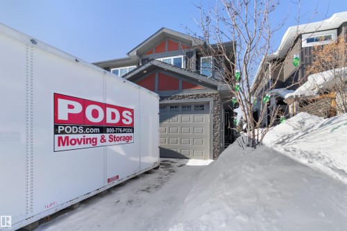 View of front of house featuring a garage and stone siding - 56 Durrand Bend, Fort Saskatchewan, AB - Outdoor
