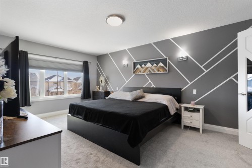 Bedroom with an accent wall and light carpet - 56 Durrand Bend, Fort Saskatchewan, AB - Indoor Photo Showing Bedroom