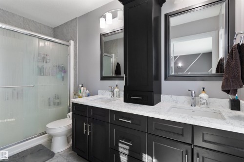 Full bath featuring double vanity and a shower stall - 56 Durrand Bend, Fort Saskatchewan, AB - Indoor Photo Showing Bathroom