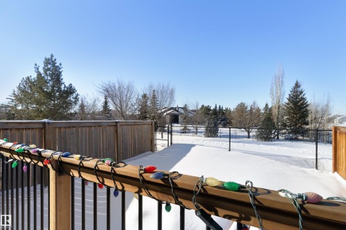 Yard covered in snow with a wooden deck - 56 Durrand Bend, Fort Saskatchewan, AB - Outdoor