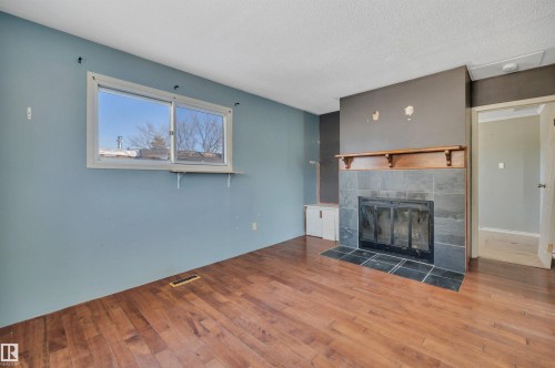 4712 49 Street, Calmar, AB - Indoor Photo Showing Living Room With Fireplace