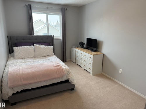 Bedroom with light carpet and baseboards - 19 2021 Grantham Crest, Edmonton, AB - Indoor Photo Showing Bedroom