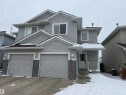 Traditional home featuring a porch, an attached garage, and driveway - 19 2021 Grantham Crest, Edmonton, AB  - Outdoor With Facade 