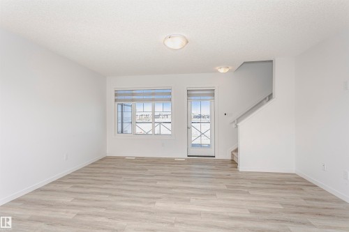 Empty room with light wood-type flooring and a textured ceiling - 2412 192 Street, Edmonton, AB - Indoor Photo Showing Other Room