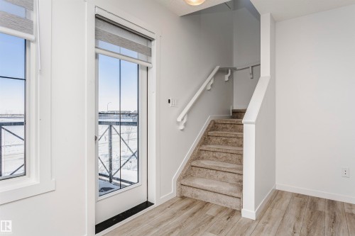 Staircase featuring wood finished floors and baseboards - 2412 192 Street, Edmonton, AB - Indoor Photo Showing Other Room