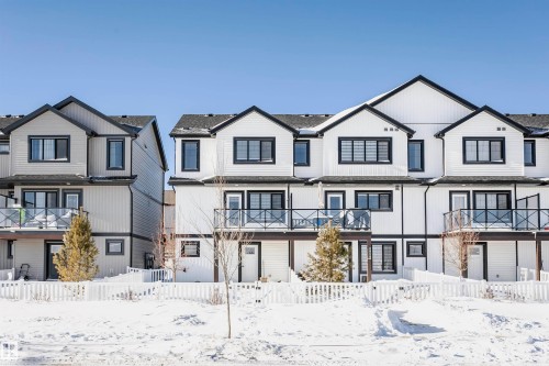 Modern farmhouse style home with a balcony and a residential view - 2412 192 Street, Edmonton, AB - Outdoor With Balcony With Facade