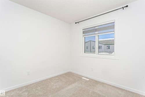 Unfurnished room featuring a textured ceiling and carpet floors - 2412 192 Street, Edmonton, AB - Indoor Photo Showing Other Room