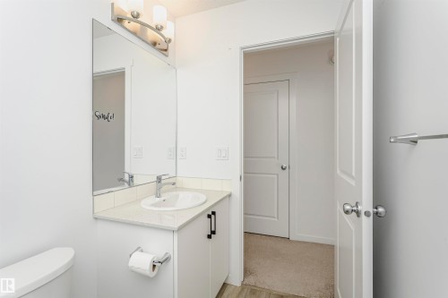 Half bathroom with vanity and light wood finished floors - 2412 192 Street, Edmonton, AB - Indoor Photo Showing Bathroom