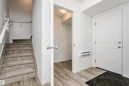 Stairs featuring wood finished floors and baseboards - 2412 192 Street, Edmonton, AB - Indoor Photo Showing Other Room