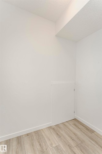 Empty room featuring a textured ceiling and light wood-style flooring - 2412 192 Street, Edmonton, AB - Indoor Photo Showing Other Room