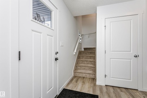 Stairway featuring a textured ceiling and wood finished floors - 2412 192 Street, Edmonton, AB - Indoor Photo Showing Other Room