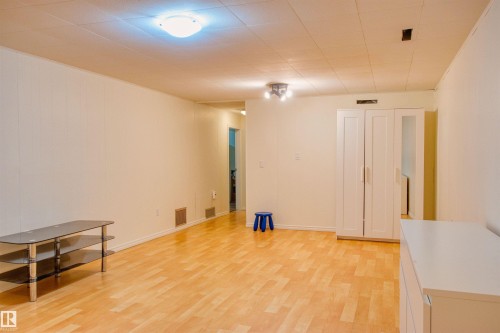 Unfurnished room featuring light wood-type flooring - 9907 165 Street, Edmonton, AB - Indoor Photo Showing Other Room