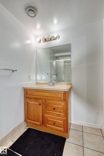 Bathroom with vanity, light tile patterned flooring, and a shower stall - 9907 165 Street, Edmonton, AB - Indoor Photo Showing Bathroom